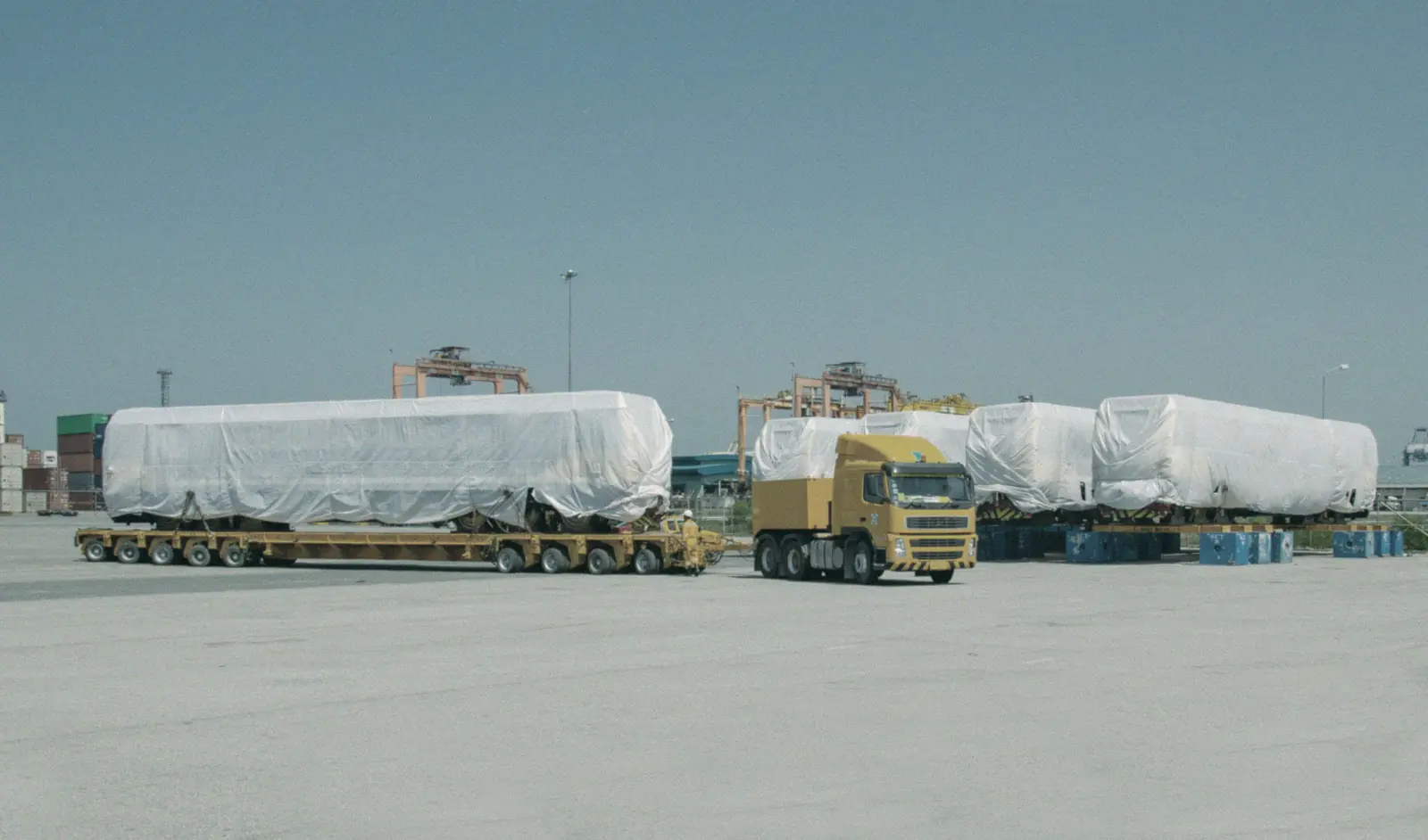 Heavy-lift cargo on low-loader trailers at a port